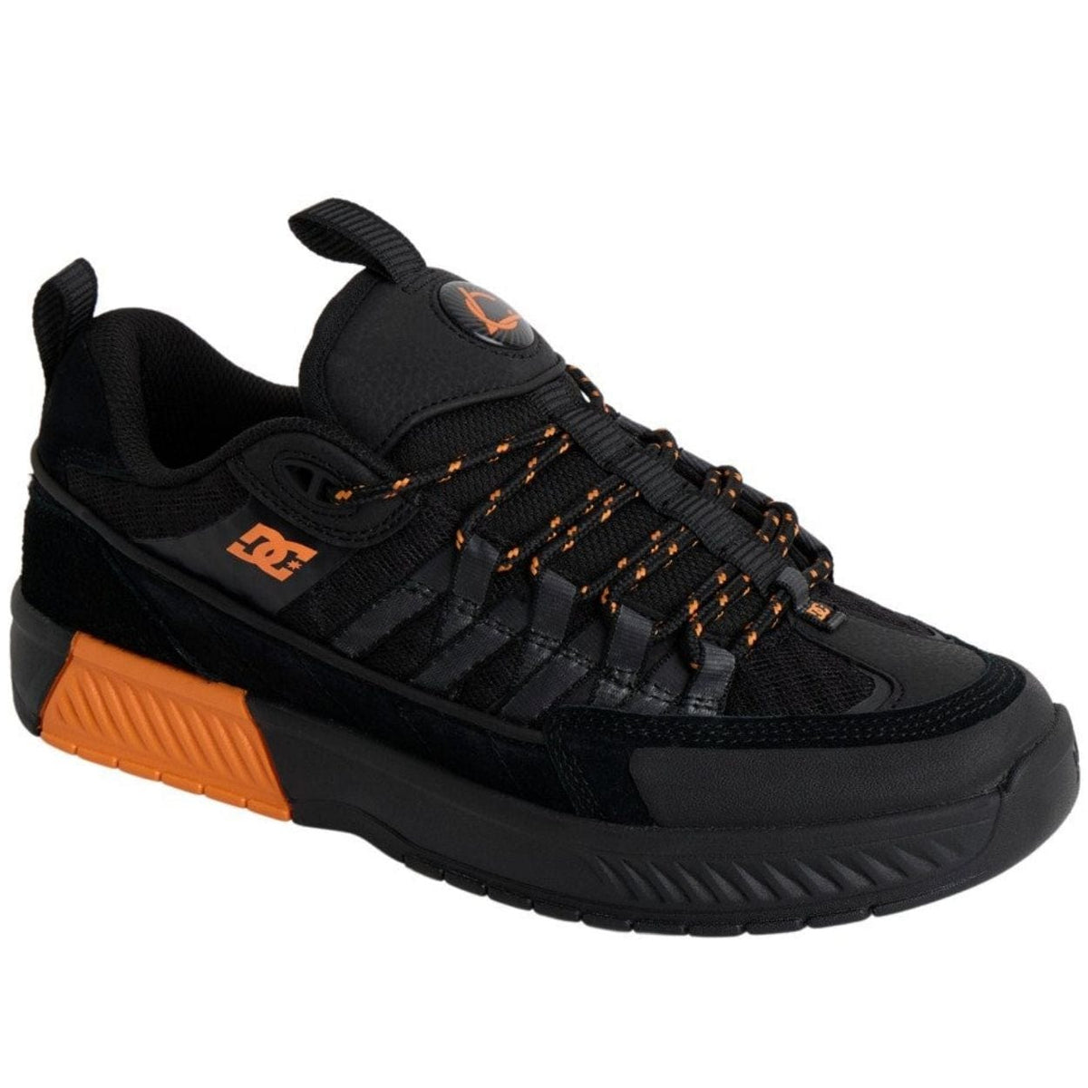 DC Shoes Lucien skate shoes in black and orange with durable canvas and rubber outsole, designed for skateboarding.