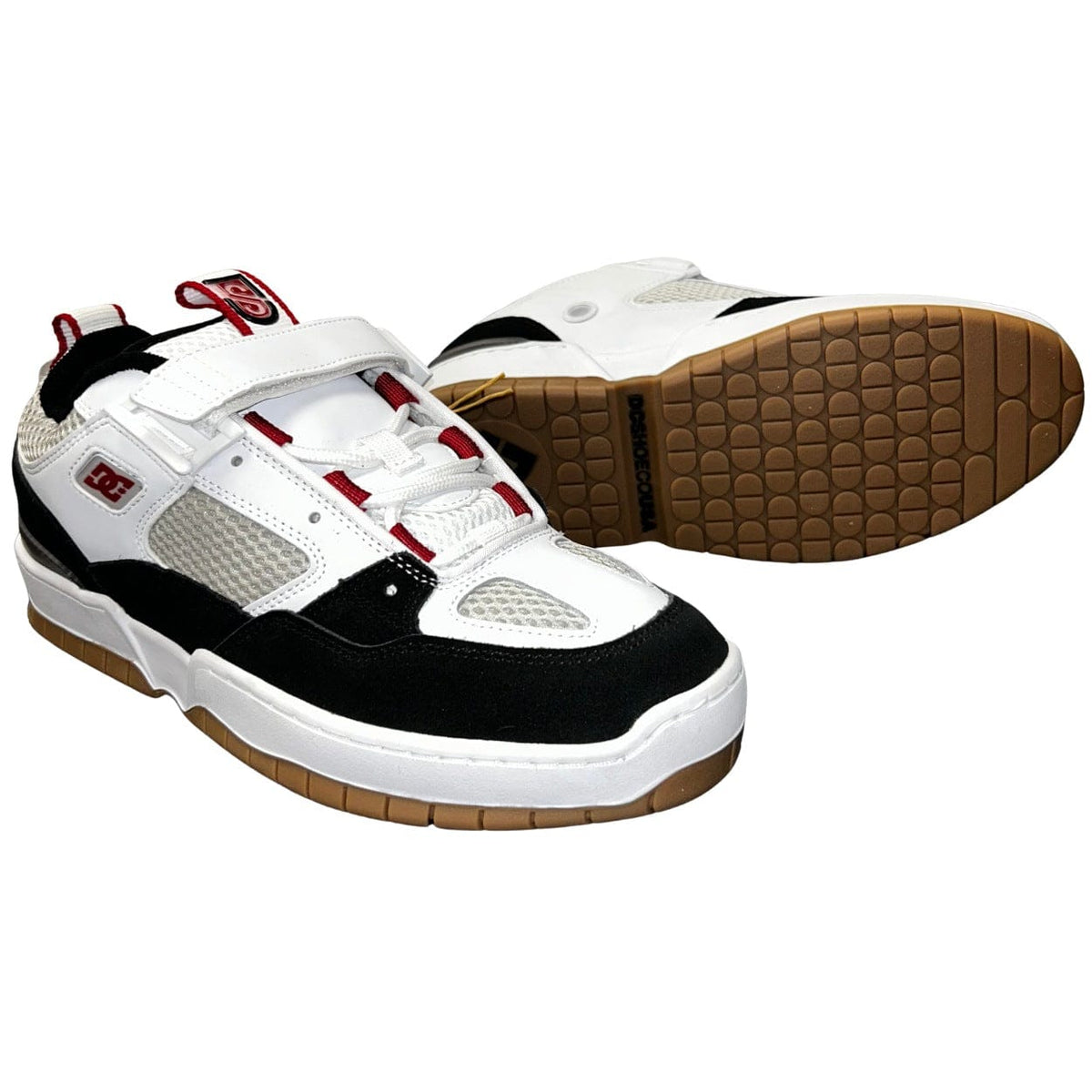 DC Shoes JS 1 skate shoes in white, black, and red with a low-profile design and skateboarding-inspired style.