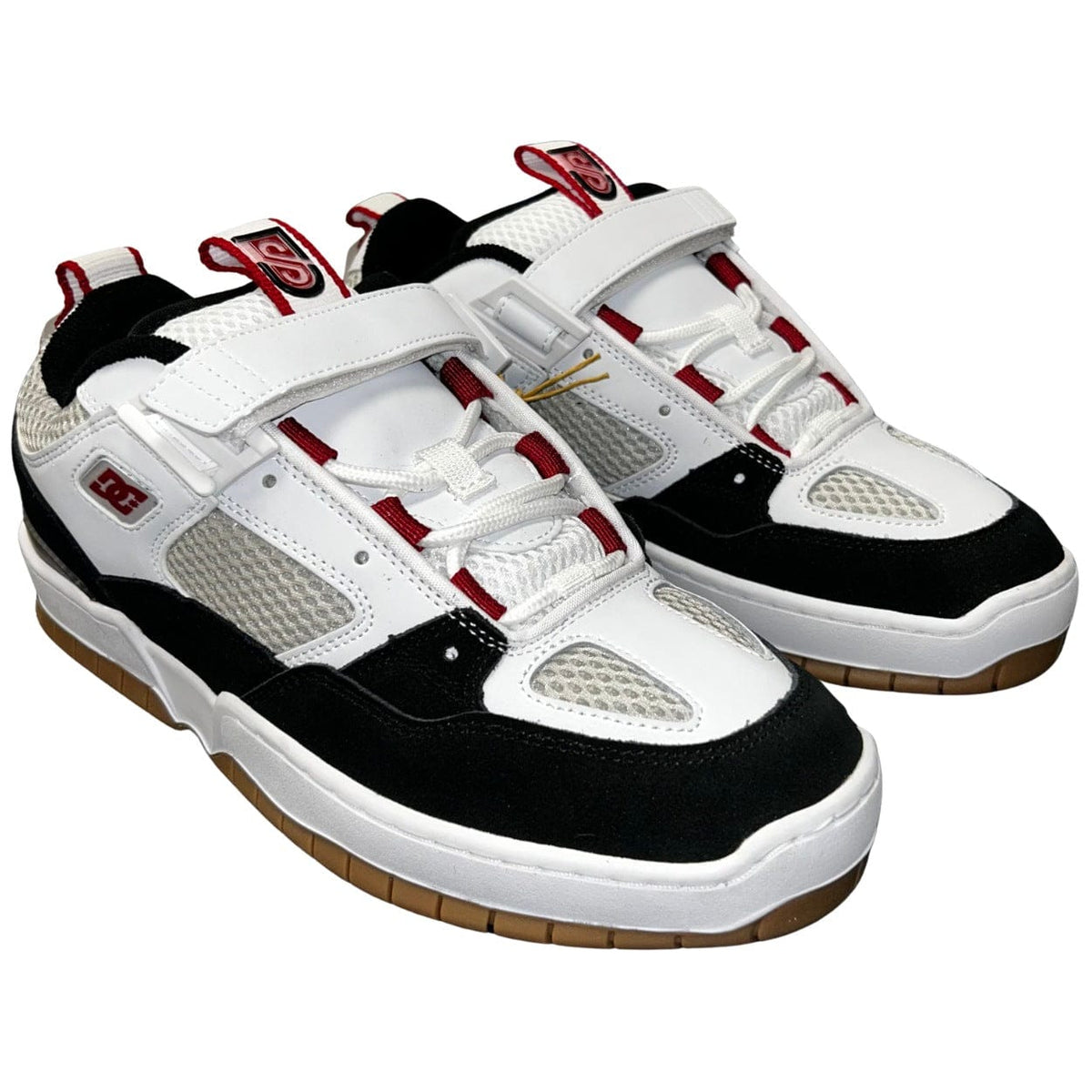 DC Shoes JS 1 skate shoes in white, black, and red with sleek design and durable sole, ideal for skating and casual wear.