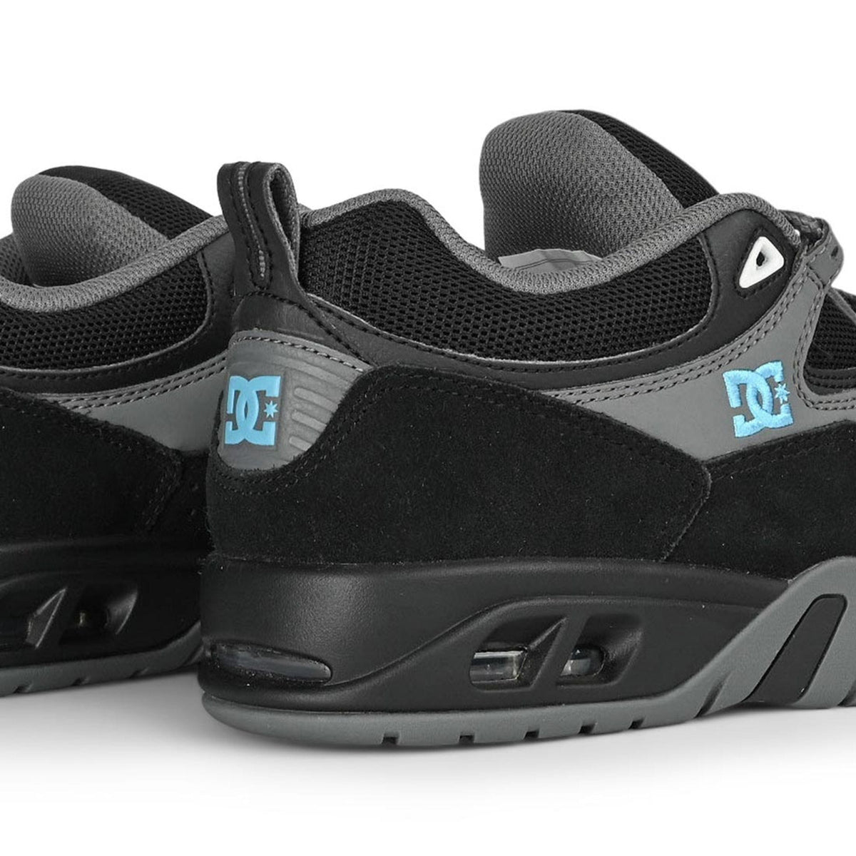 DC Shoes Truth skate shoes in black, grey, and blue with a low-top design and classic skateboarding style.