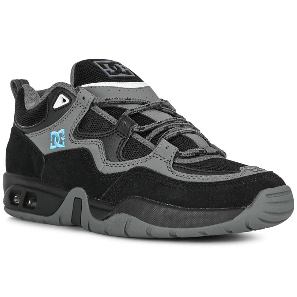 DC Shoes Truth skate shoes in black, grey, and blue with a low profile and sturdy design suitable for skateboarding.