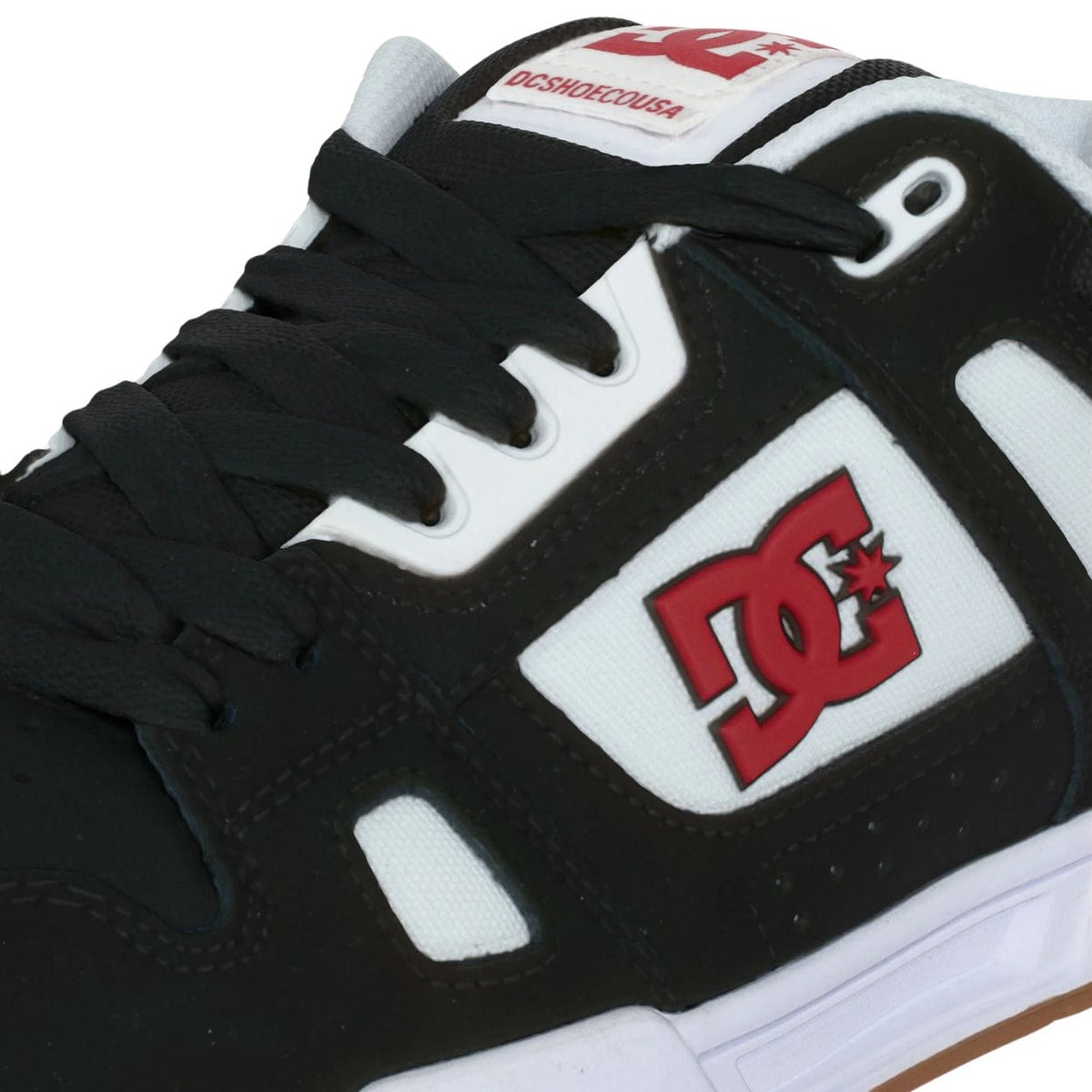 DC Stag skate shoes in black, white, and red with a low-top design and classic skate style from DC Shoes.