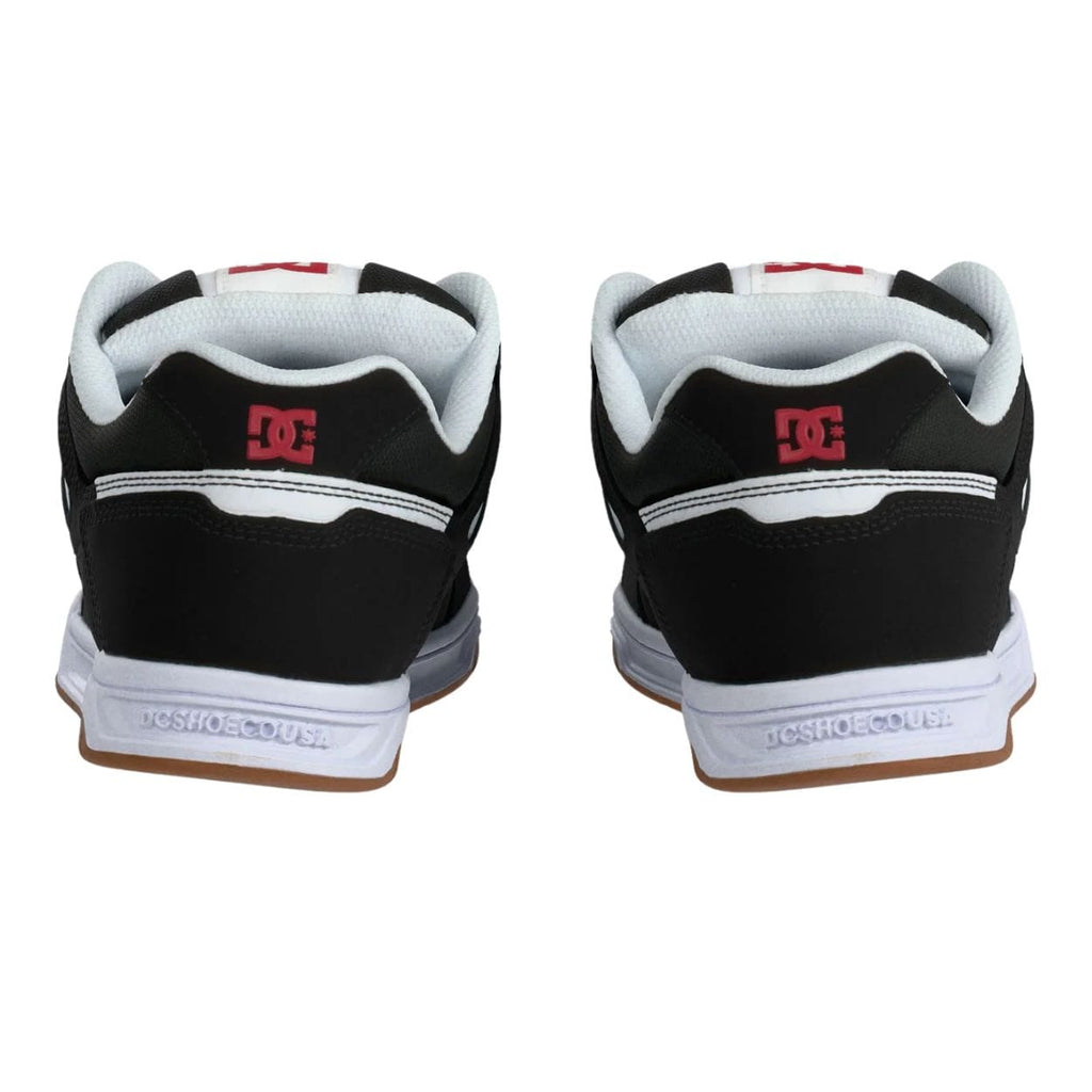 DC Stag skate shoes in black, white, and red with classic design and skateboarding-inspired details.