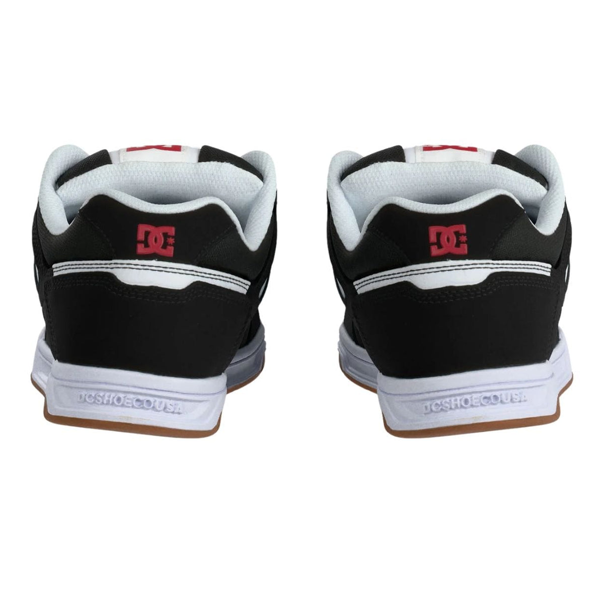 DC Stag skate shoes in black, white, and red with classic design and skateboarding-inspired details.