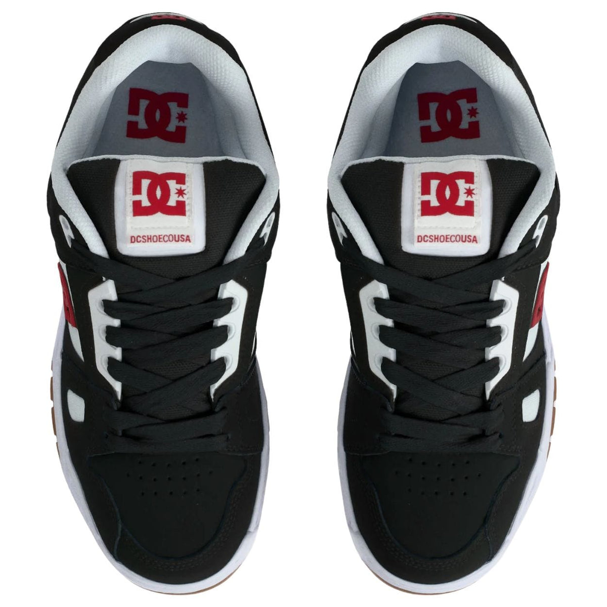DC Stag skate shoes in black, white, and red with classic skate shoe design and logo details, suitable for skateboarding and casual wear.