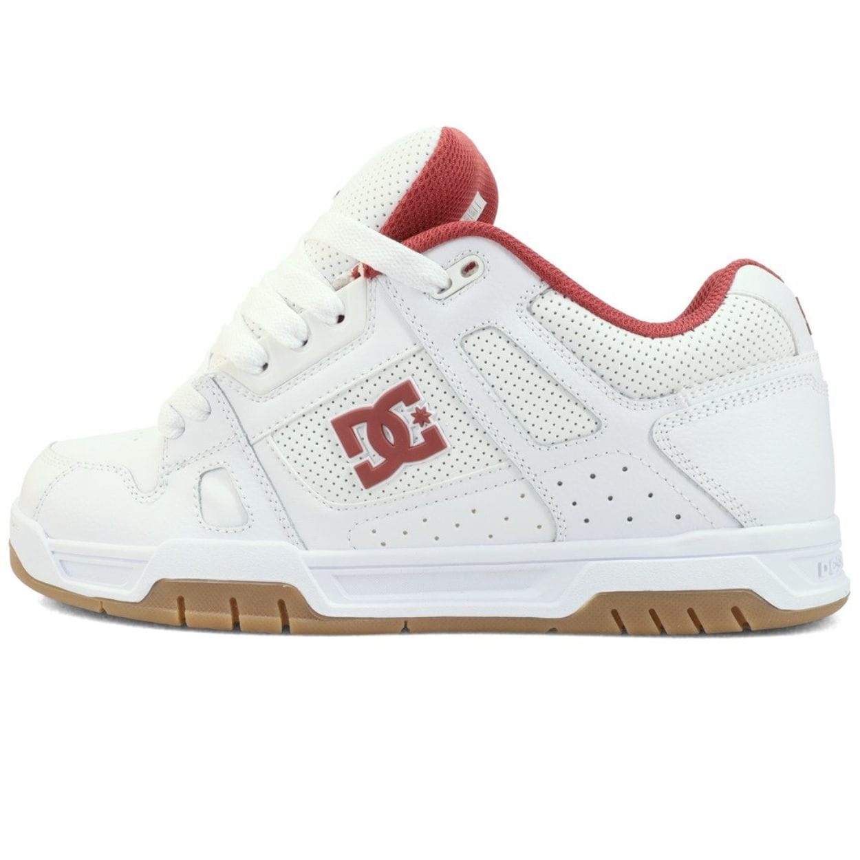 White DC Stag skate shoes with black accents, durable rubber sole, and classic skateboarding style from DC Shoes.