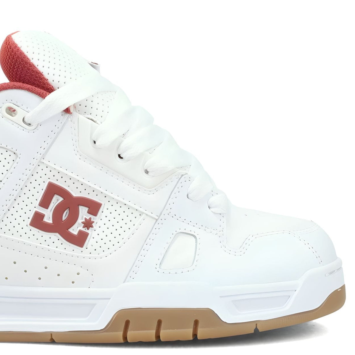 White DC Stag skate shoes with low-top design, flat laces, and iconic DC logo, perfect for skateboarding and casual wear.