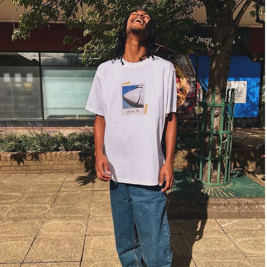 White Dime MTL Plane T-Shirt featuring a printed airplane graphic on the front, made of soft cotton fabric.
