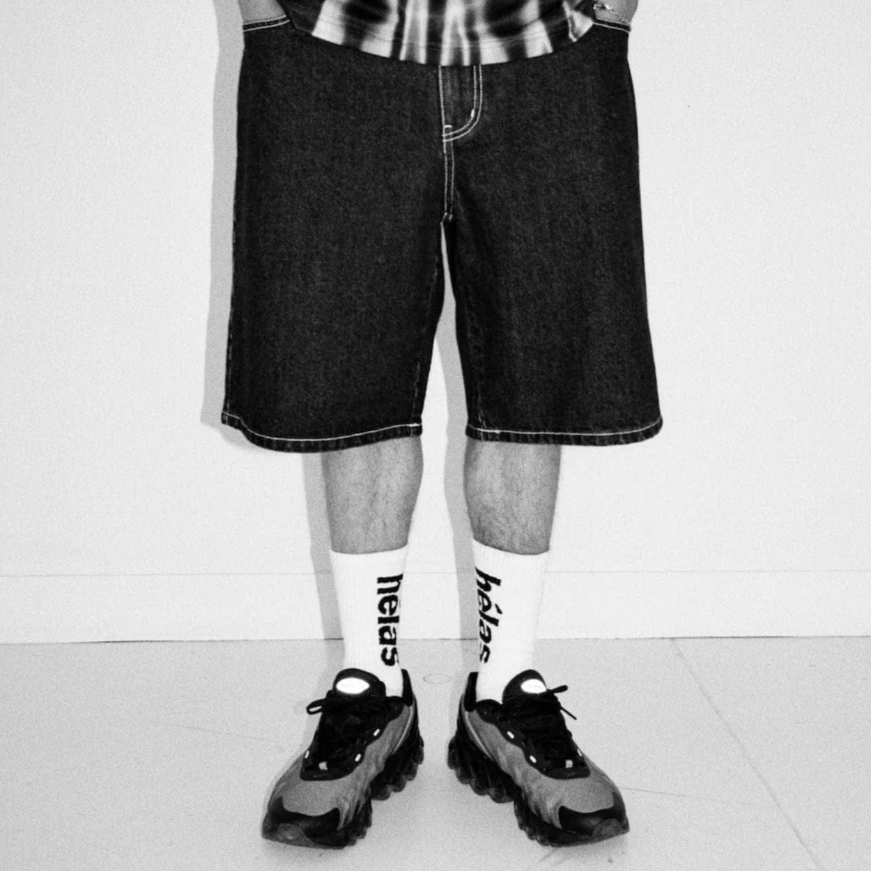 Helas Dieu Grec Jean Shorts in washed black denim, featuring a relaxed fit and stylish design with logo details.