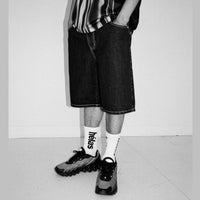 Helas Dieu Grec Jean Shorts in washed black fabric, showcasing casual denim style with a relaxed fit and distressed detailing.