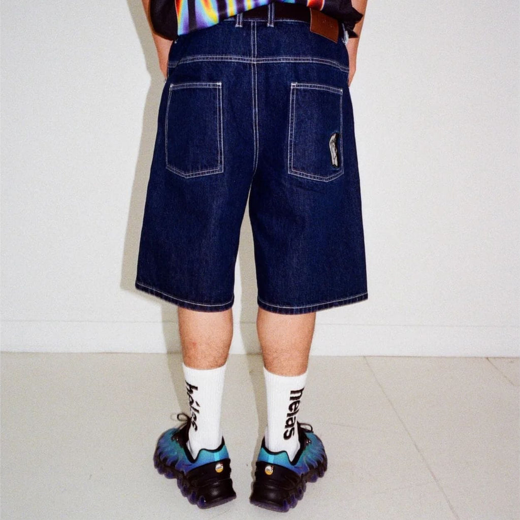 Helas Dieu Grec Jean Shorts in washed navy denim, featuring a casual fit and distressed details, styled for summer wear.