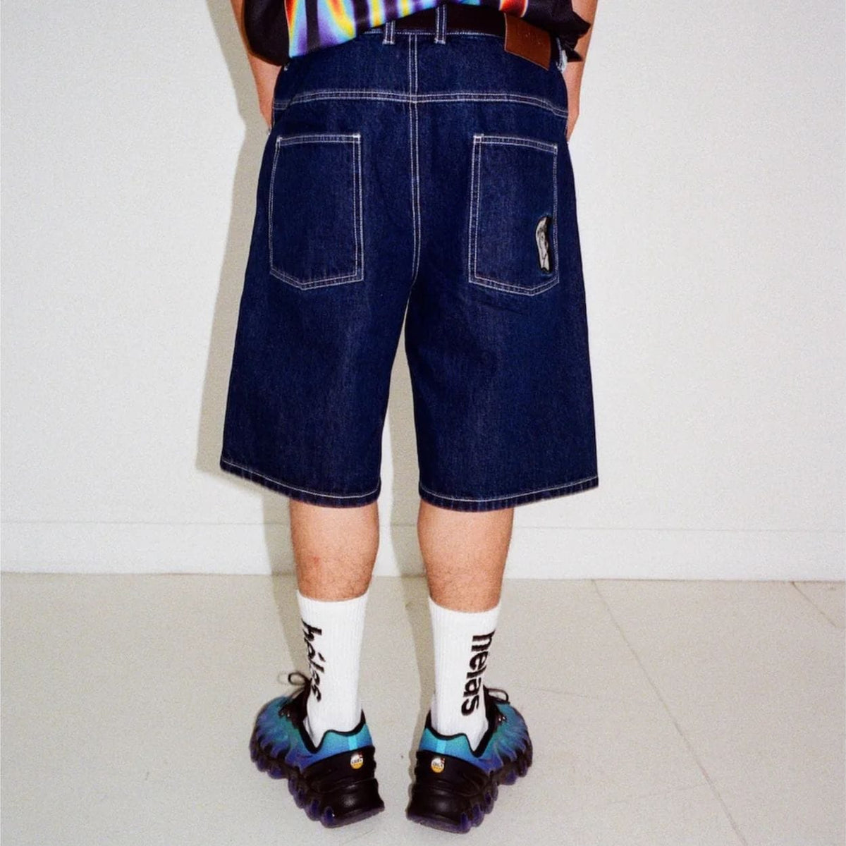 Helas Dieu Grec Jean Shorts in washed navy denim, featuring a casual fit and distressed details, styled for summer wear.