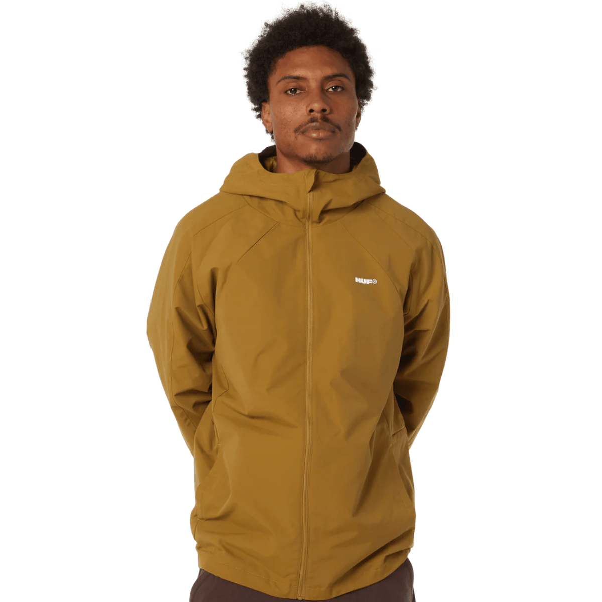 HUF All Caps Shell Jacket in rich brown, featuring a lightweight, waterproof design with hood and zippered pockets.