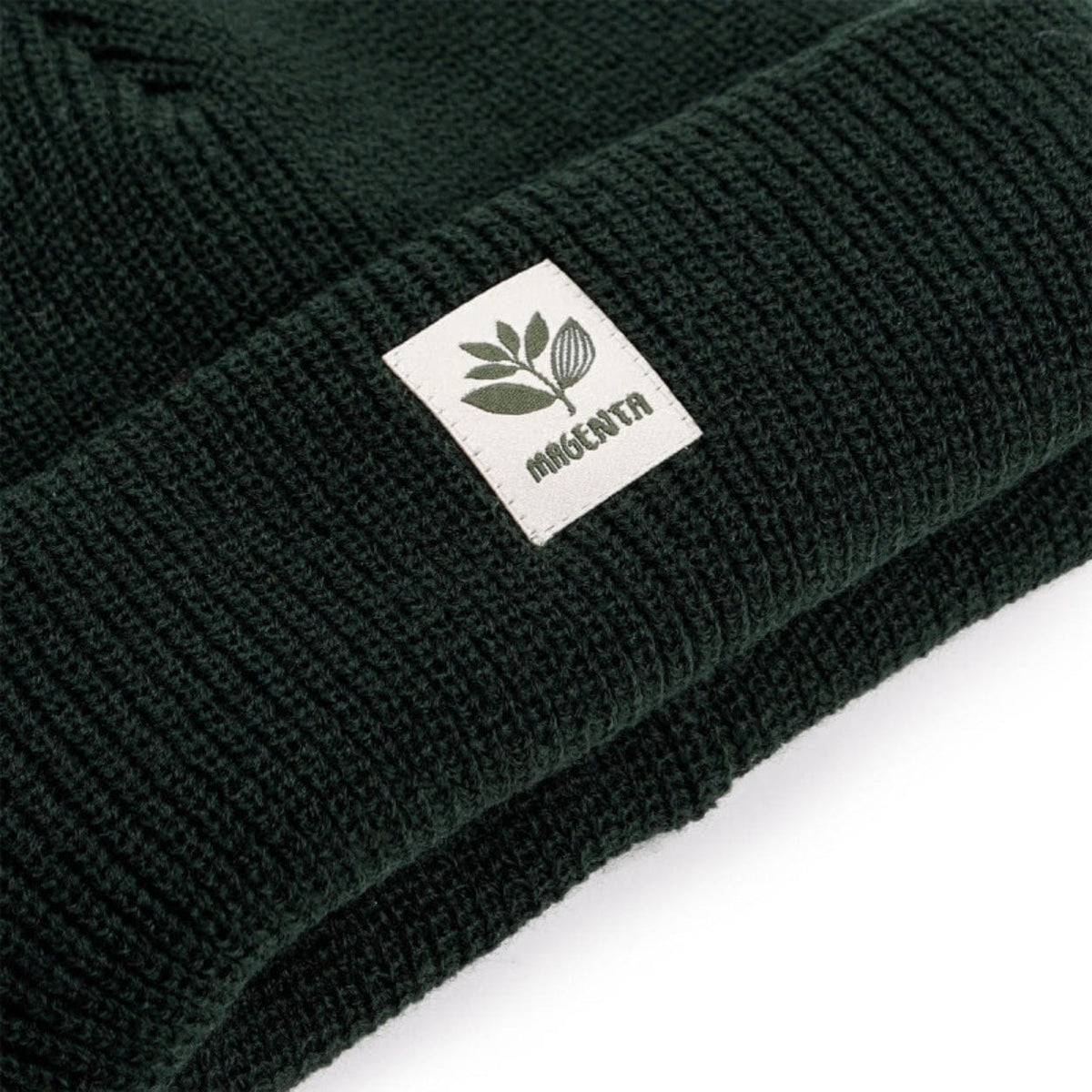 Magenta Skateboards Fam beanie in forest green, soft knit fabric, featuring the Magenta logo for casual skate style.