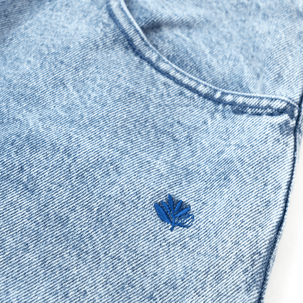 Magenta Skateboard OG denim jeans with washed finish, featuring denim stitching and relaxed fit, casual streetwear style.