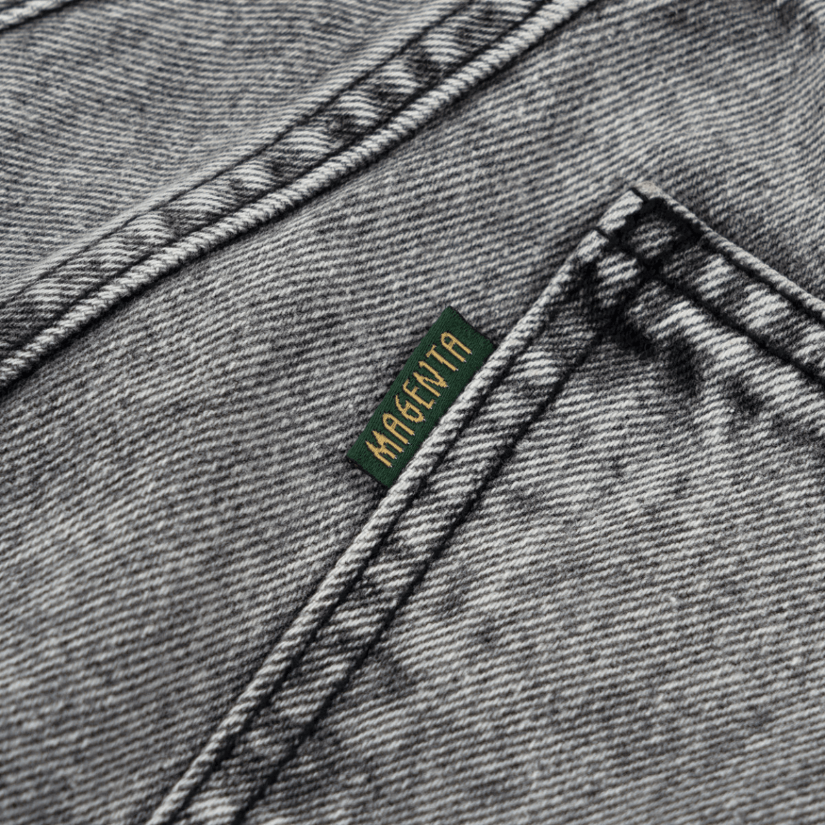 Magenta Skateboards OG Denim Stitch Jeans in acid wash showing the fit and detailed stitching on the casual denim pants.