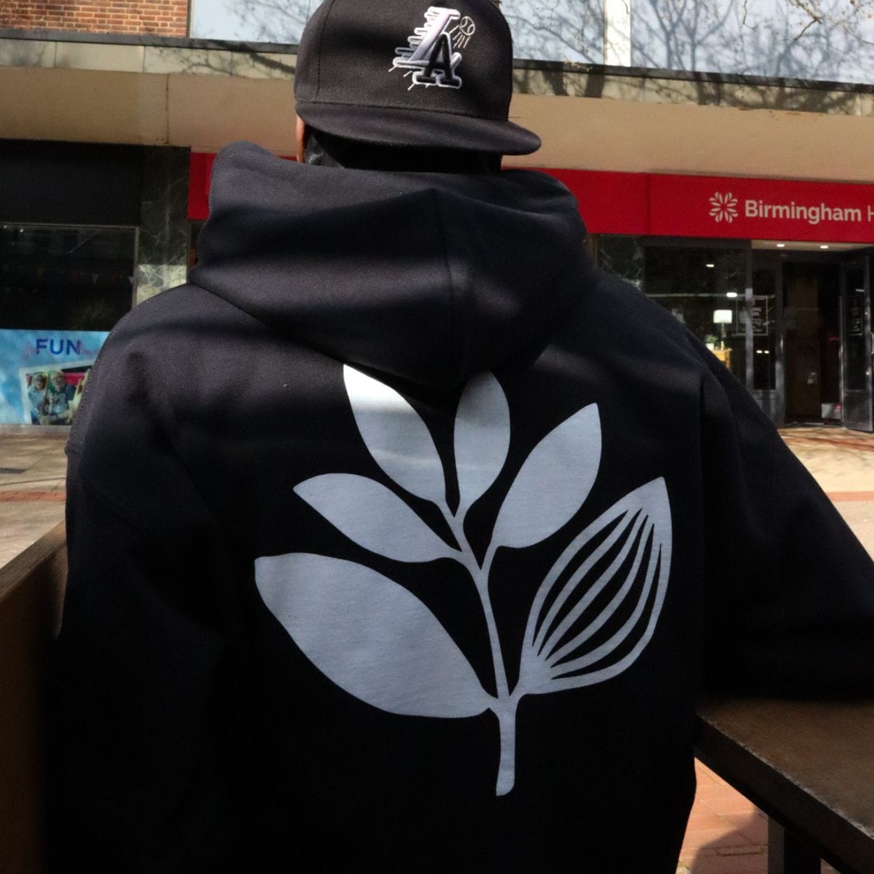 Magenta Skateboards Plant hoodie in black, featuring a colorful plant graphic on the front, casual fit and soft fabric for skateboarding.