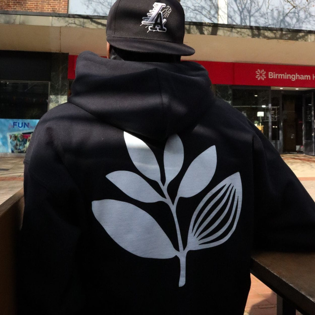 Magenta Skateboards Plant hoodie in black, featuring a colorful plant graphic on the front, casual fit and soft fabric for skateboarding.