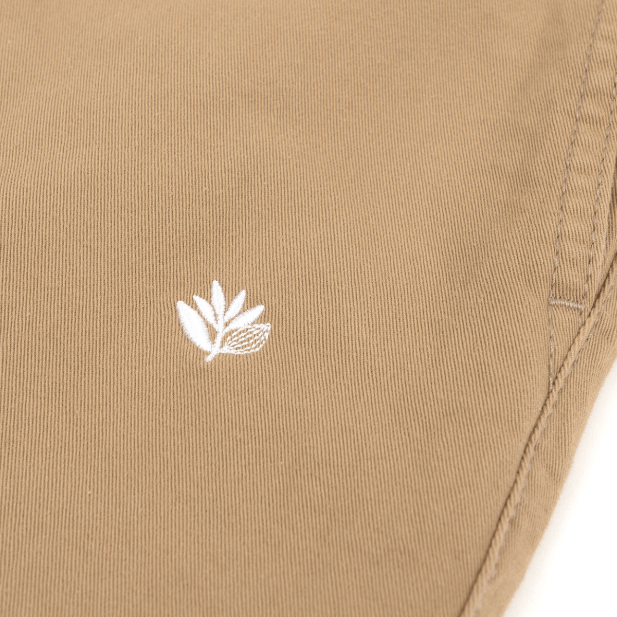 Beige Magenta Skateboards Slack Pants, casual trousers with a relaxed fit and subtle branding, perfect for skateboarding or everyday wear.