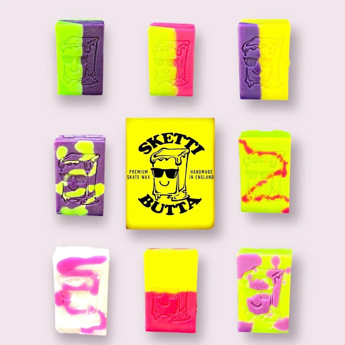 Assorted Sketti Butta OG skateboard wax in colorful containers, ideal for enhancing grip on skateboards and ramps.
