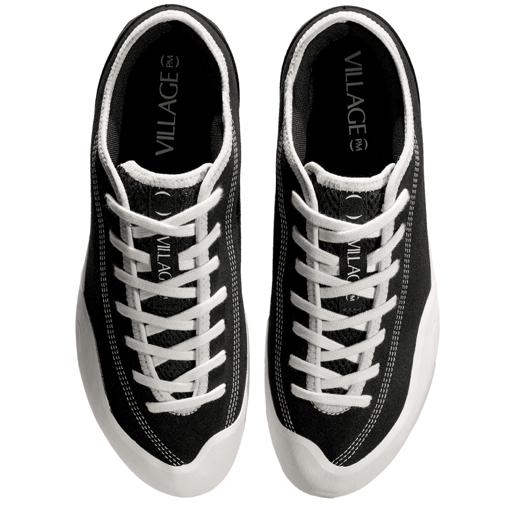 Village PM 1:30 PM skate shoes in black and white, canvas design, casual footwear for skateboarding and everyday wear.